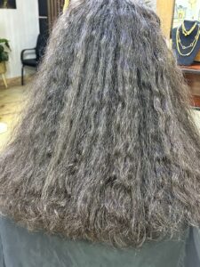 Before hair treatment at Sanaa Ahmed Beauty Salon in New Cairo showing dry, frizzy, damaged hair before smoothing and hair care service at a women’s beauty salon