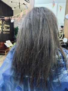 Before hair smoothing service at Sanaa Ahmed Beauty Salon in New Cairo showing rough, frizzy hair inside a women’s beauty salon before professional hair treatment
