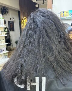 Client hair before treatment at Sanaa Ahmed Beauty Salon in New Cairo showing dry, frizzy, unmanageable hair before smoothing and repair service at a beauty salon