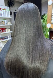Client hair after treatment at Sanaa Ahmed Beauty Salon in New Cairo showing soft, straight, glossy hair after a professional beauty salon and hair smoothing service