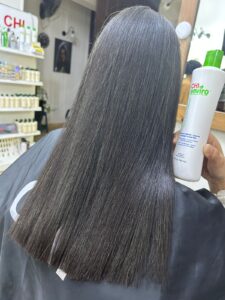 After result of CHI Enviro hair treatment at Sanaa Ahmed Beauty Salon in New Cairo showing smooth, sleek, shiny hair after professional smoothing treatment