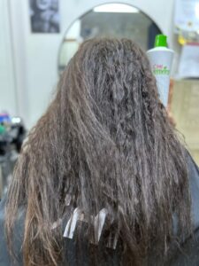 Before CHI Enviro smoothing treatment at Sanaa Ahmed Beauty Salon in New Cairo showing dry, frizzy hair before professional hair salon treatment and smoothing service