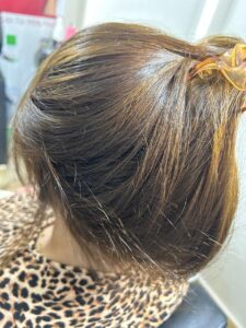 Close up of hair color work at a beauty salon in New Cairo featuring blended brown tones and subtle highlights, showing professional coloring techniques by Sanaa Ahmed Beauty Salon for smooth, healthy and natural looking results