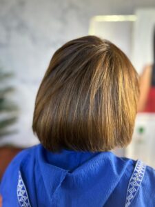 Short bob haircut with soft highlights done at a beauty salon in New Cairo, showing precise cutting and natural color blending by Sanaa Ahmed Beauty Salon for women looking for clean, modern hairstyles and easy maintenance looks