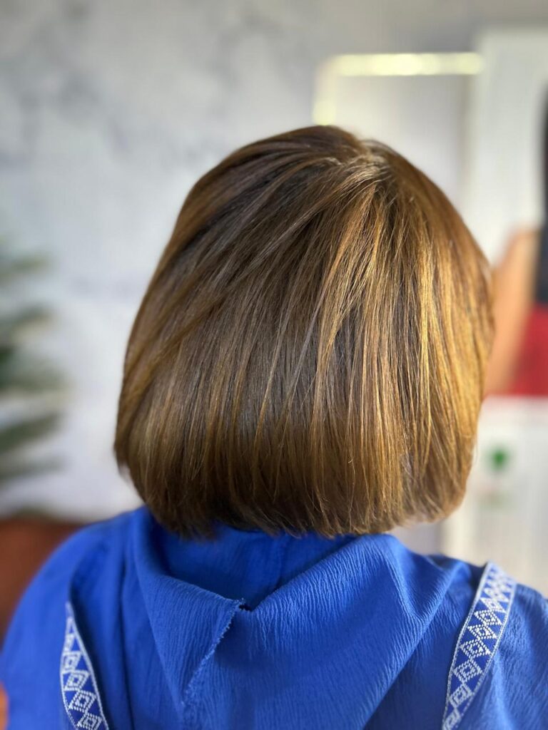 beauty salon new cairo short bob haircut highlights Short bob haircut with soft highlights done at a beauty salon in New Cairo, showing precise cutting and natural color blending by Sanaa Ahmed Beauty Salon for women looking for clean, modern hairstyles and easy maintenance looks