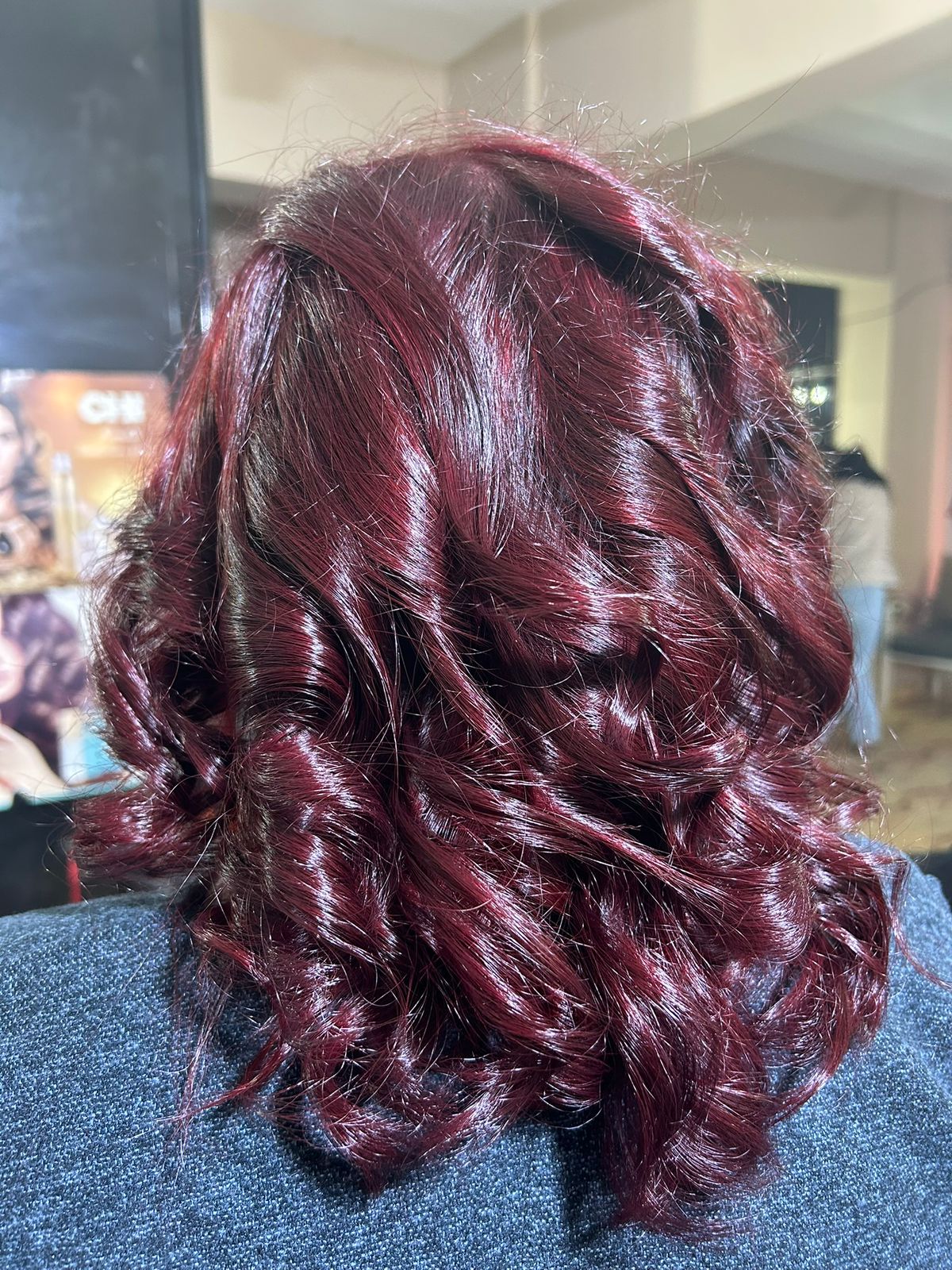 Glossy burgundy curls hair color at Sanaa Ahmed Beauty Salon, New Cairo