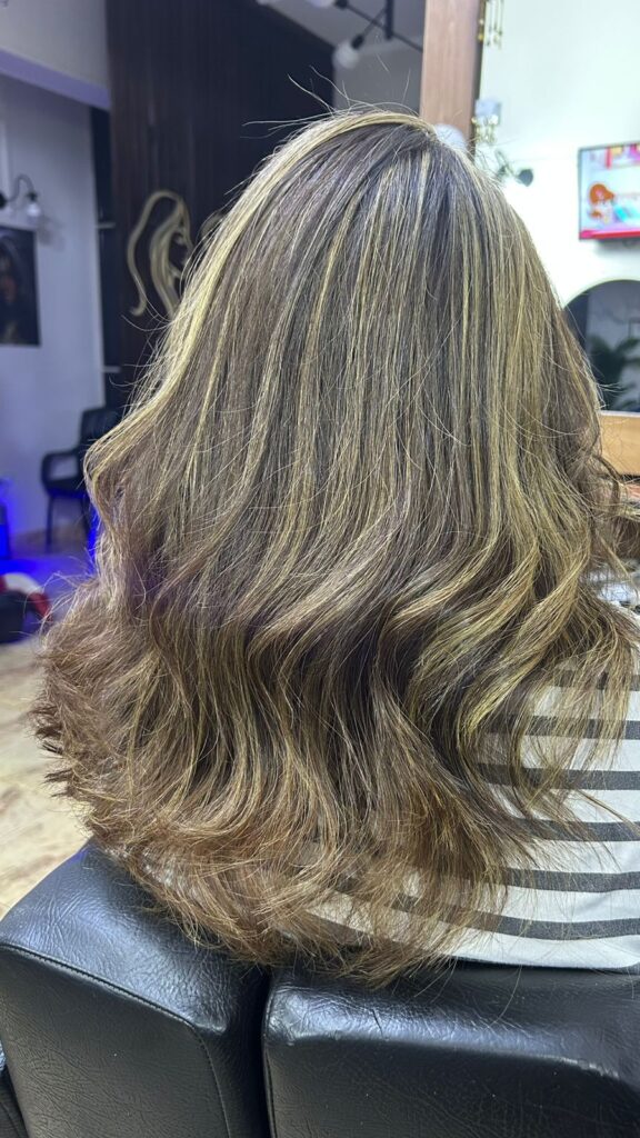 Professional highlighted wavy hair styling at Sanaa Ahmed Beauty Salon near Zahret El Tagamo3 New Cairo